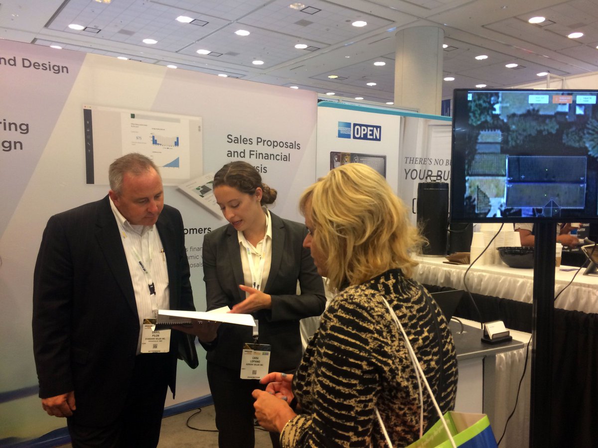 Aurora Sales Development Representative talks with Intersolar booth visitors.