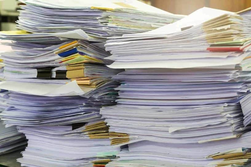 Stack of papers indicating a lot of paperwork to process