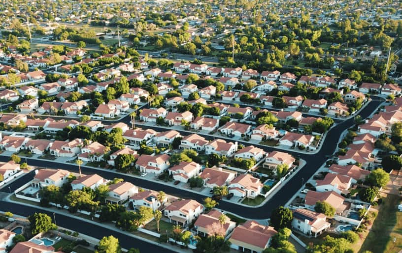 Aerial view of a suburban neighborhood with winding roads and houses