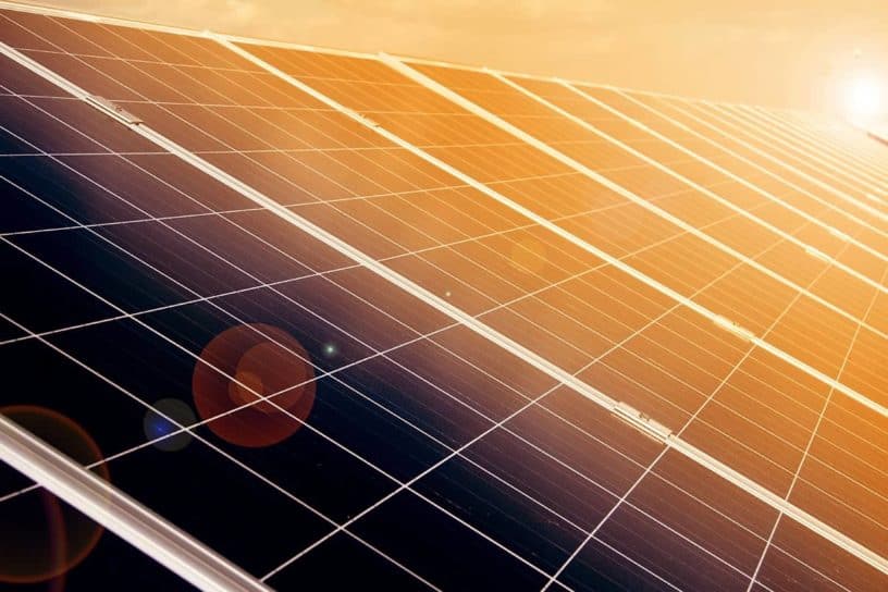 Close-up of a solar panel with sunlight reflecting off its surface