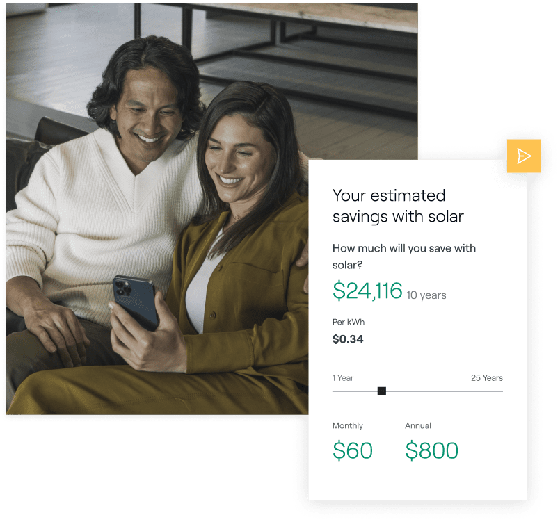 Two individuals smiling while looking at a phone that displays a solar savings estimate advertisement.