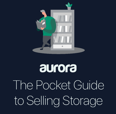 Man perusing a manual titled 'the pocket guide to selling storage' next to a bookshelf, under the aurora brand logo.