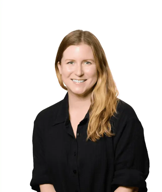 A smiling woman with long hair wearing a black shirt against a white background.